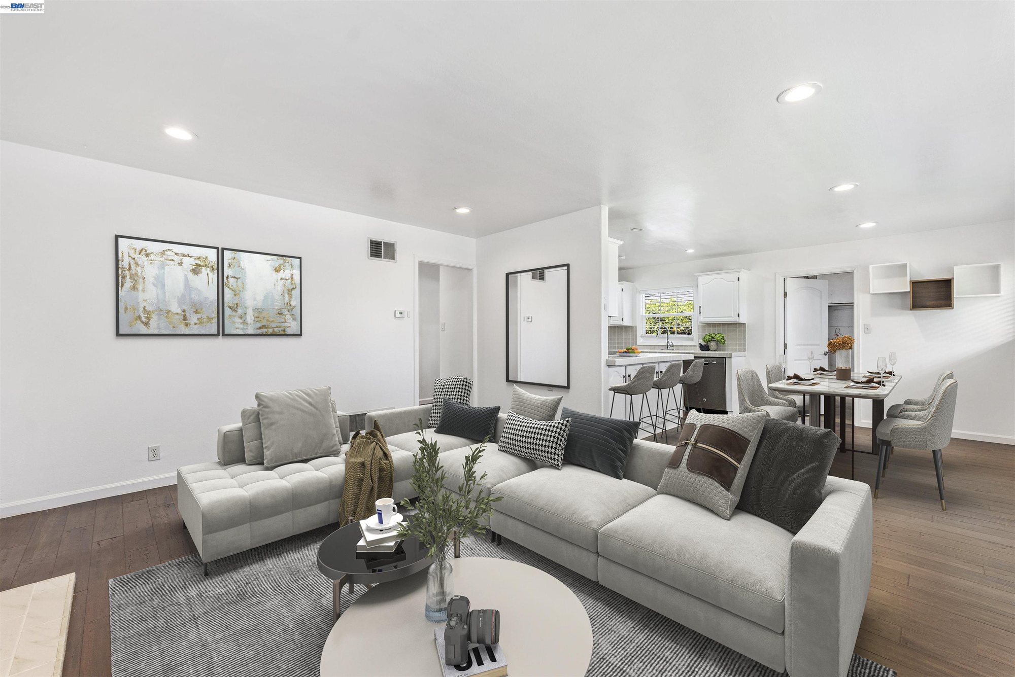 Living room staged with sofas open to the dining area