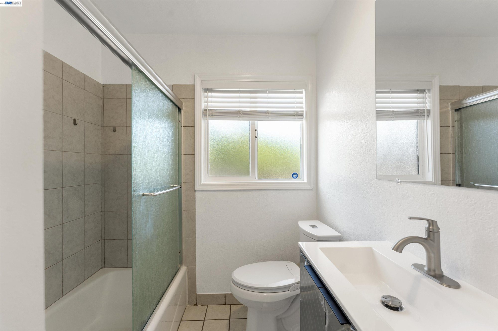 Full bath with shower over tub and updated vanity