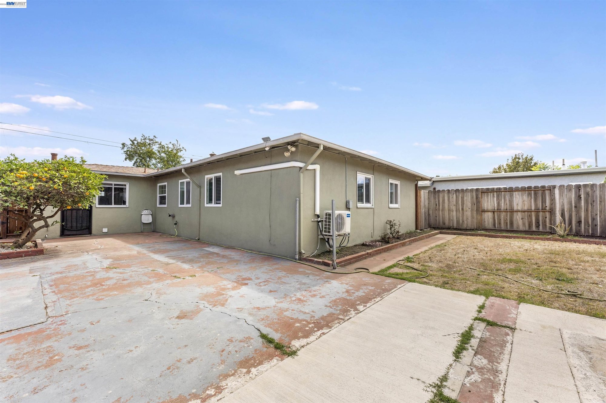 Concrete patio and detached bonus room in the backyard