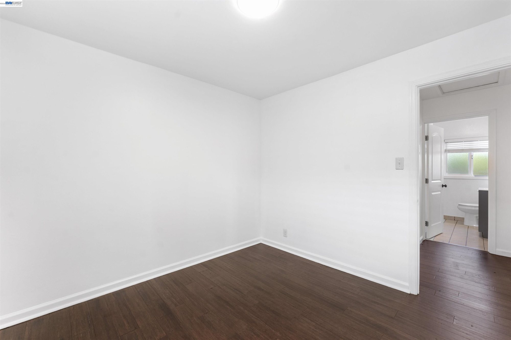 Second bedroom with hardwood-look flooring