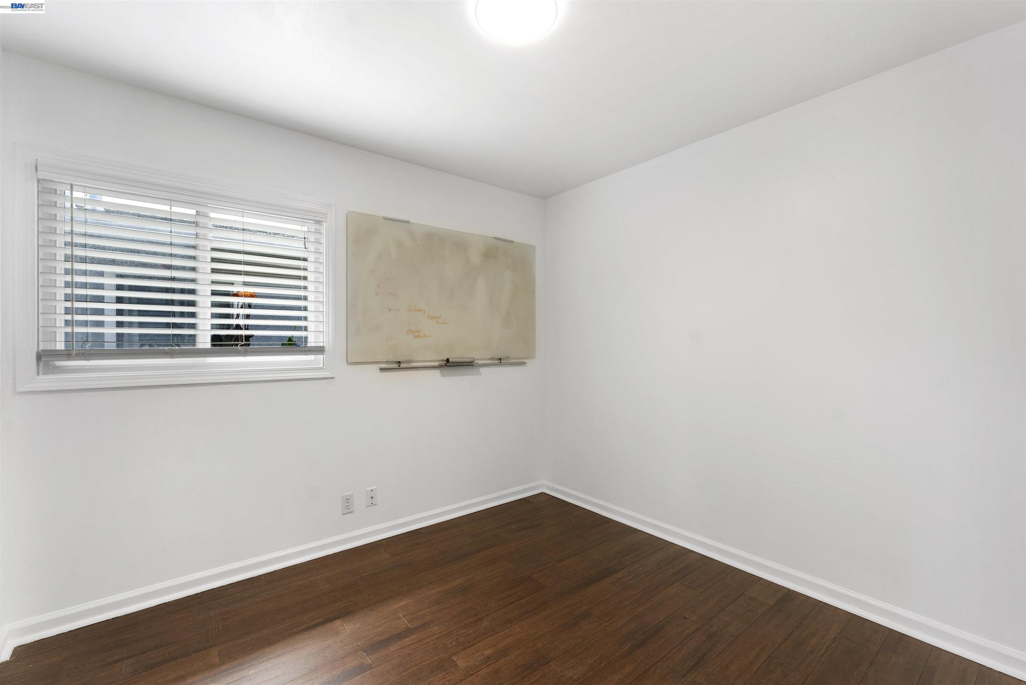 Bedroom with blinds and hallway access