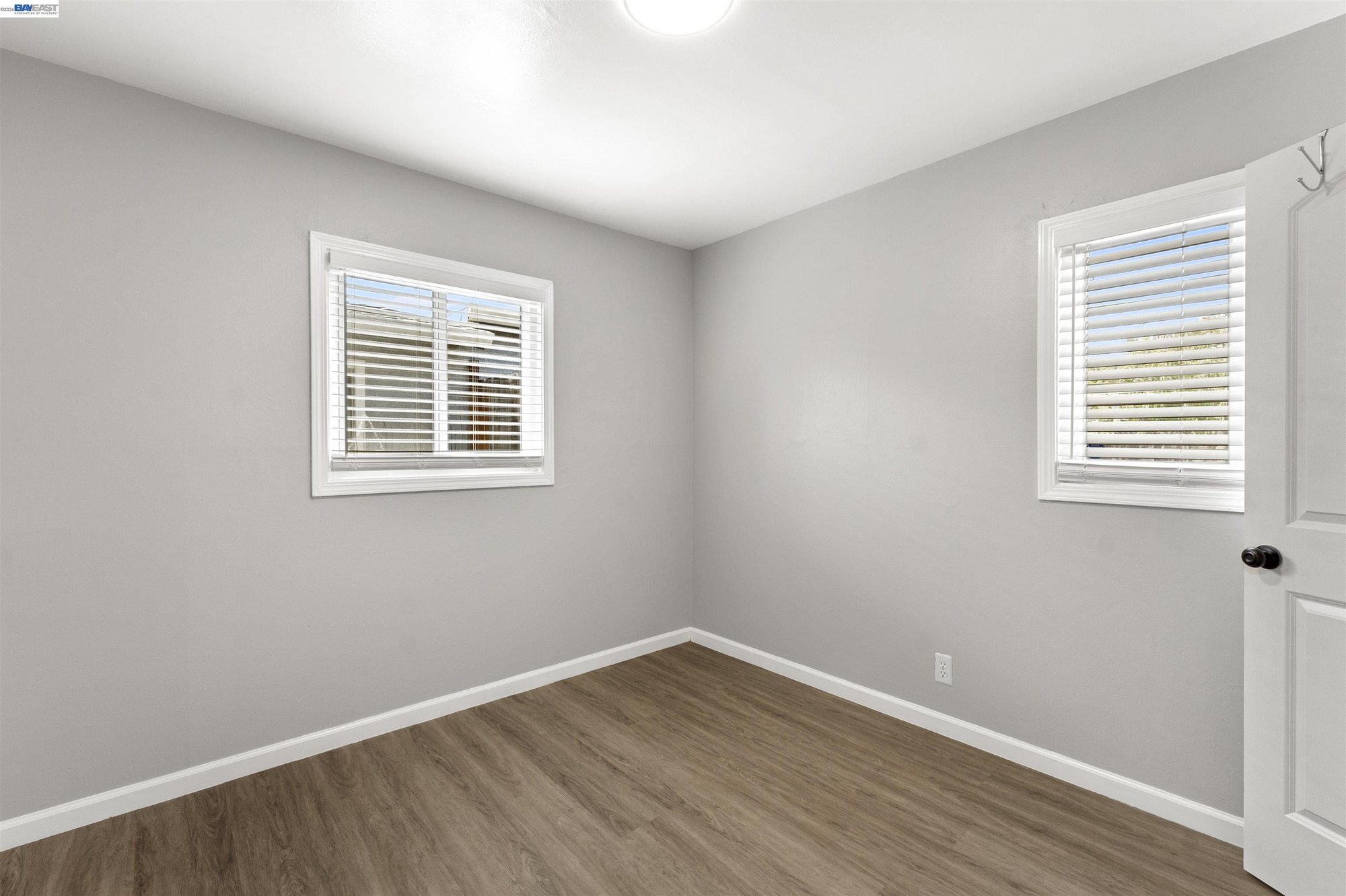 Primary bedroom with dual windows and closet